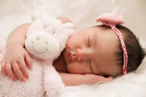 baby sleeping with plush toy